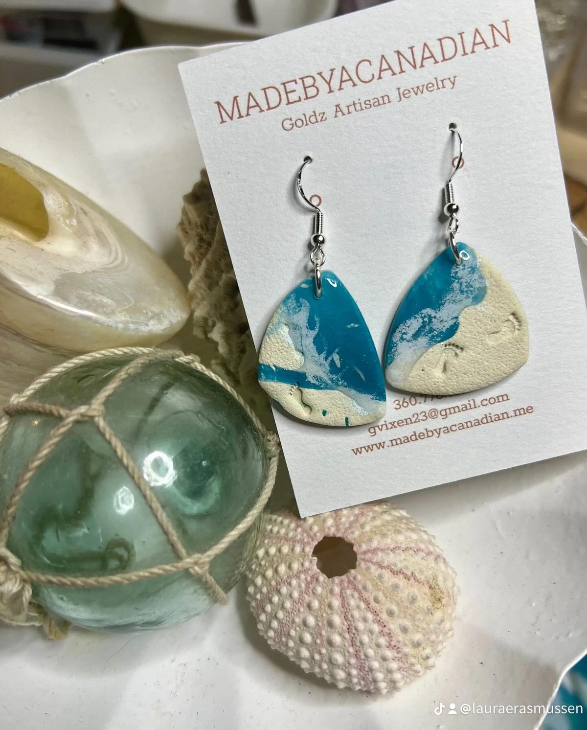 Custom blue pebble earrings inspired by a trip to the Bahamas, shown with sea glass and shells