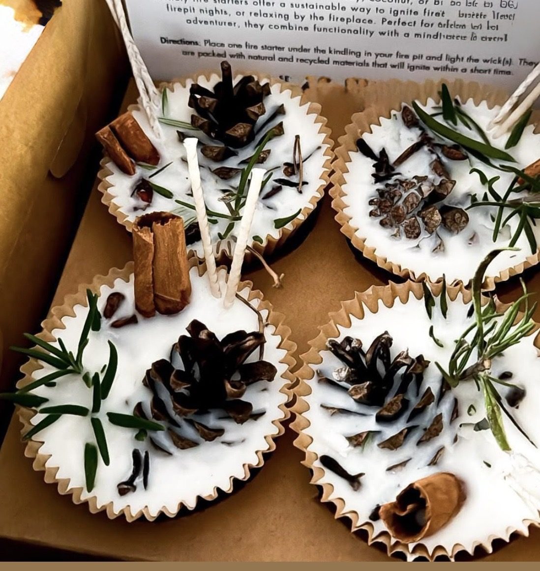 Fire starters in paper cups, topped with pine cones, cinnamon sticks and rosemary
