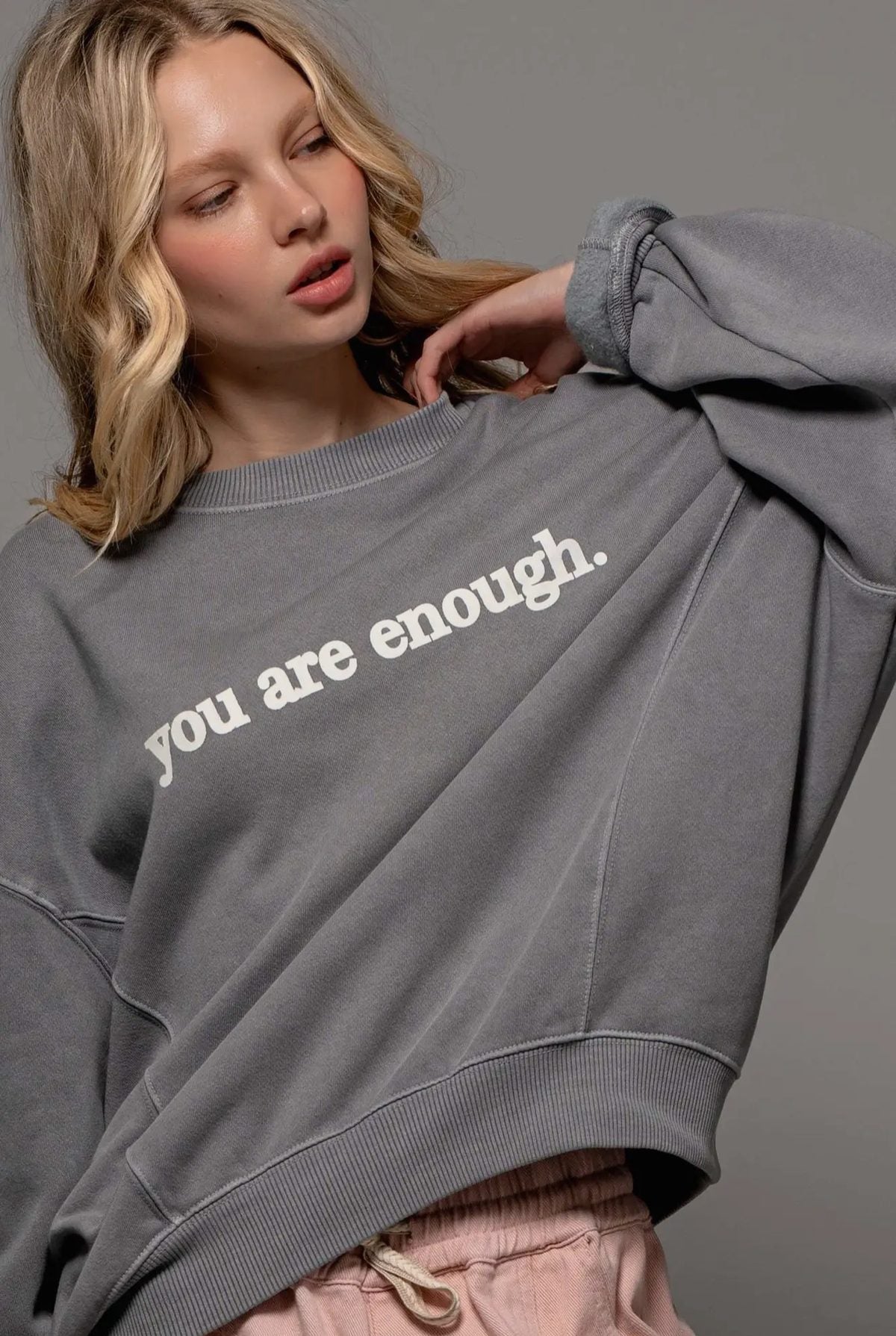 Model wearing the grey You Are Enough crew sweatshirt
